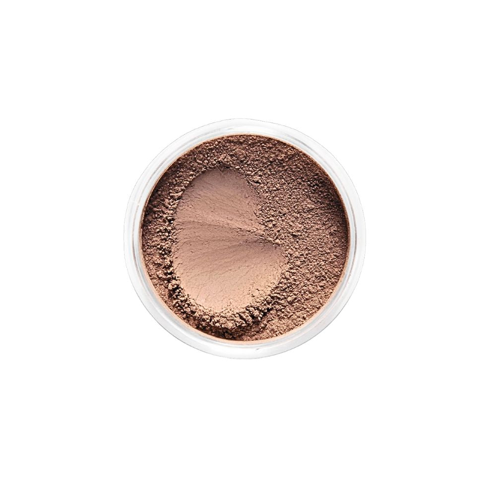 Top-down view of Dr. Berrettini's Mendocino Minerals 'Sheerly Flawless Foundation - Chestnut' in a round container, featuring a rich color with warm tones and a distinct indentation, suitable for dark to deep skin.