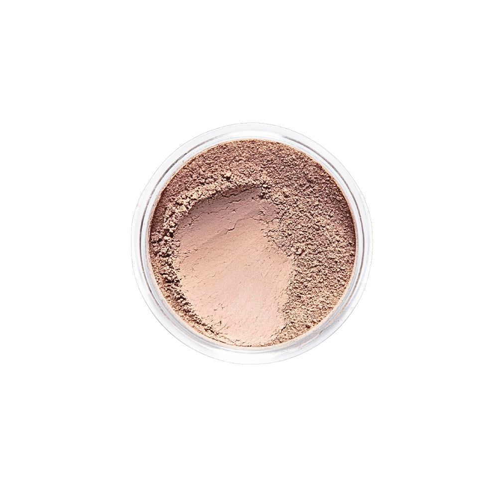 Top-down view of Dr. Berrettini's Mendocino Minerals 'Sheerly Flawless Foundation - Honey' in a round container, featuring a radiant color with warm tones and a distinct indentation, suitable for medium to tan skin.