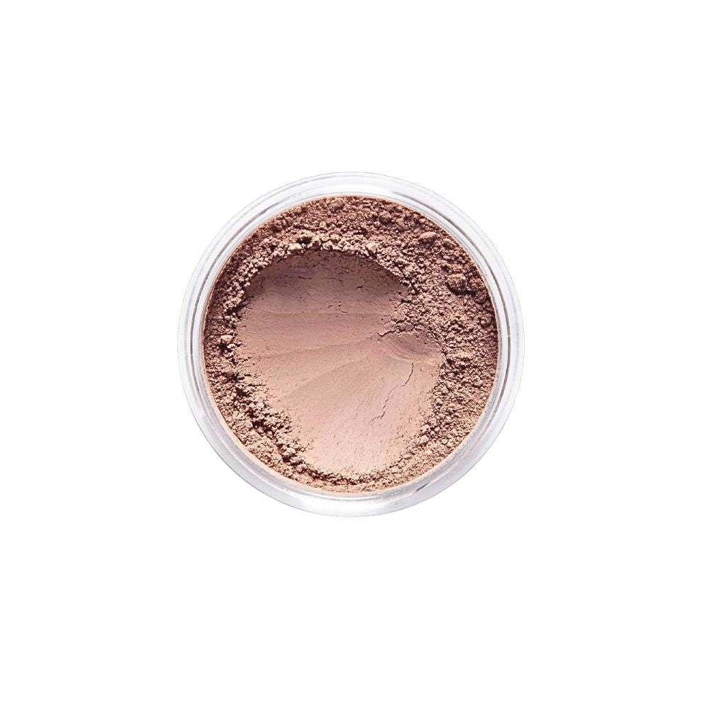 Top-down view of Dr. Berrettini's Mendocino Minerals 'Sheerly Flawless Foundation - Sandstone' in a round container, featuring a neutral or beige-like tone with versatile undertones and a distinct indentation, suitable for dark tan to dark skin.