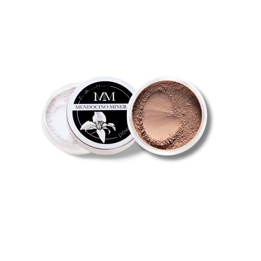 Top-down view of Dr. Berrettini's Mendocino Minerals 'Sheerly Flawless Foundation - Chestnut' in a round container, presenting a rich warm color with a distinct indentation, ideal for dark to deep skin.