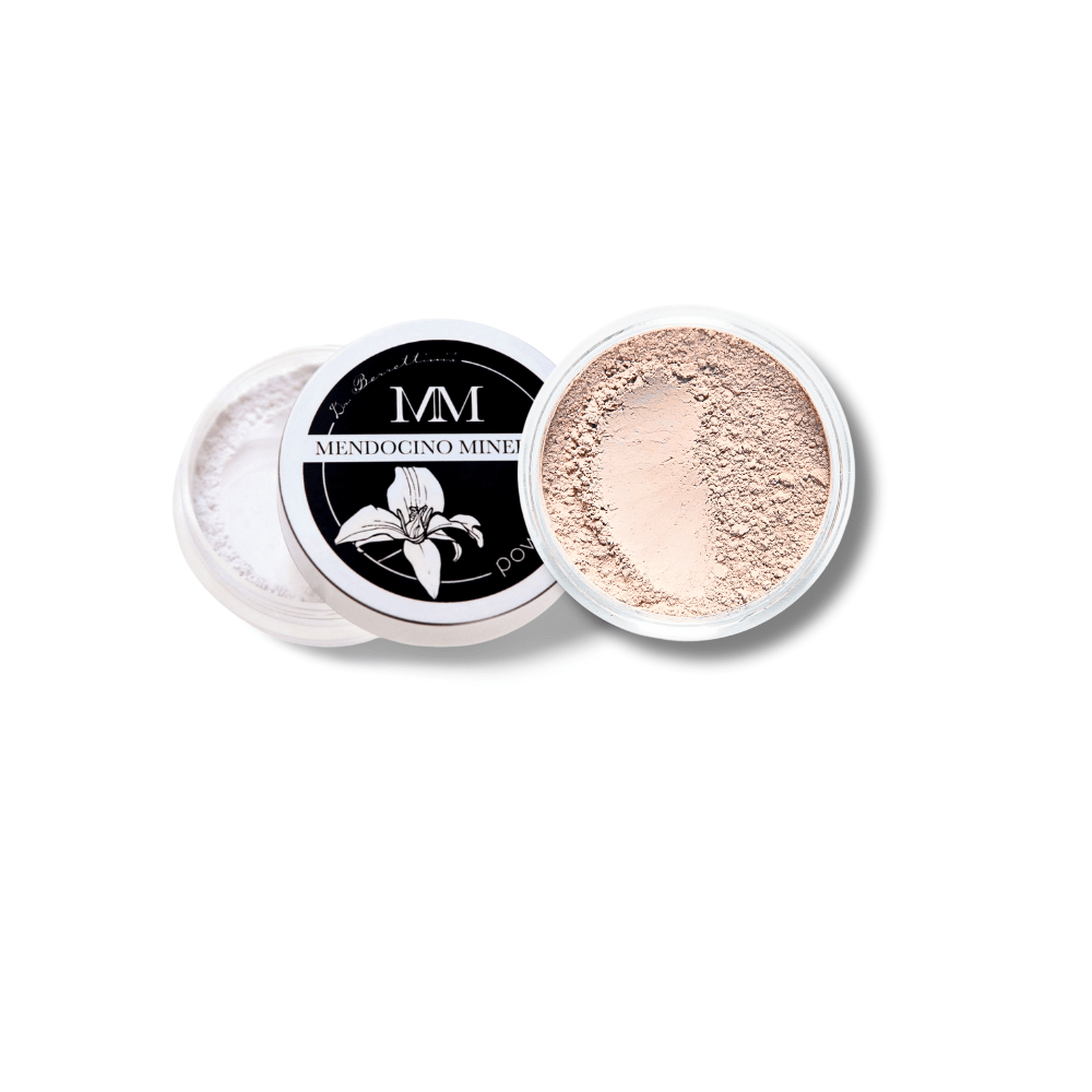 Top-down view of Dr. Berrettini's Mendocino Minerals 'Sheerly Flawless Foundation - Morning Light' in a round container, featuring a peachy, fairly neutral tone with a distinct indentation, suitable for light skin tones.